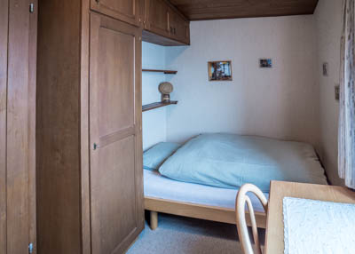 engelberg vacation rental apartment bedroom with 2 single beds and view towards mount titlis