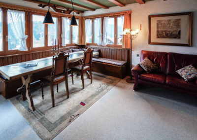 engelberg vacation apartment living room with large table and view on Mount Titlis